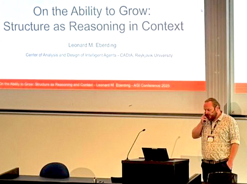 Still from Eberding's AGI-25 lecture